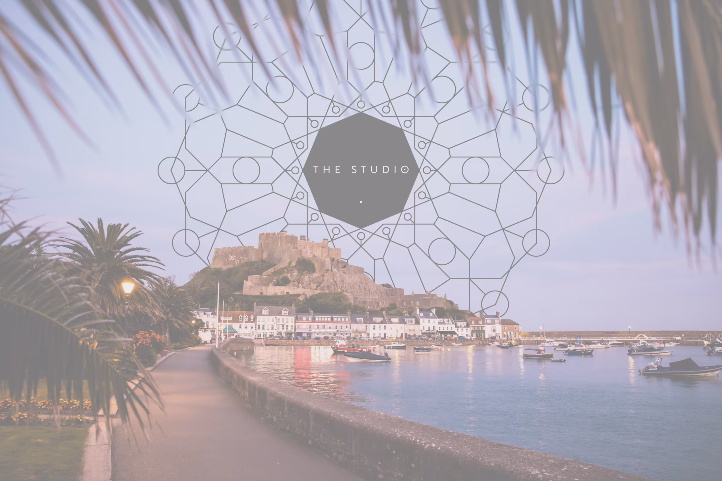 Gorey harbour and Mont Orgueil Castle at dusk, with The Studio's mandala